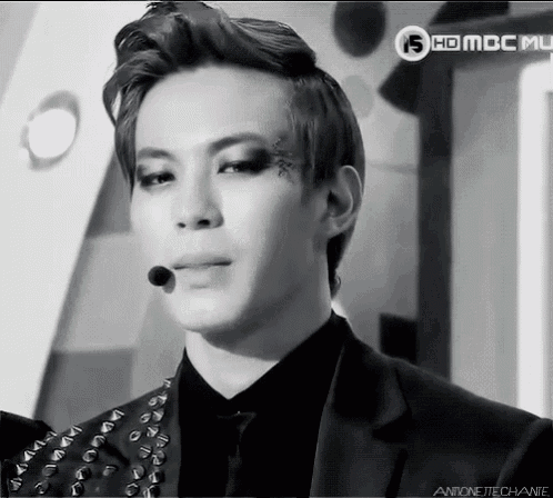 a black and white photo of a man with a microphone and the words hd mbc music on the bottom