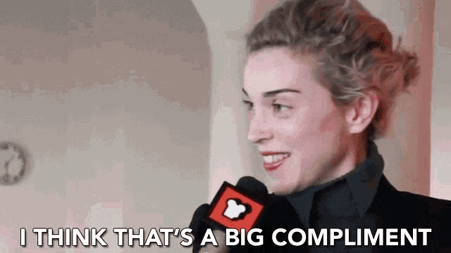 a woman talking into a microphone with the words i think that 's a big compliment