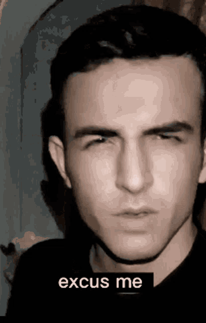 a close up of a man 's face with the words " excuse me " above it