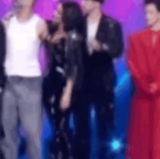 a blurry picture of a group of people standing next to each other .