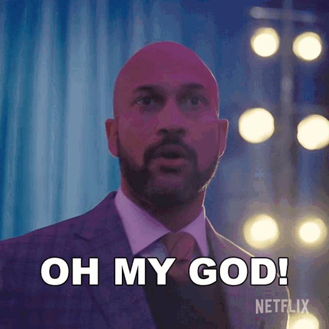 a man in a suit and tie is saying " oh my god "