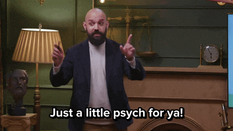 a man with a beard stands in front of a fireplace with the words trying to keep you on your toes above him