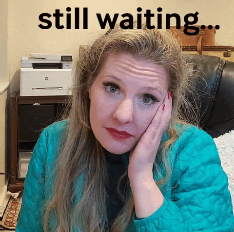 a woman sitting in a chair with her hand on her face and the words still waiting below her