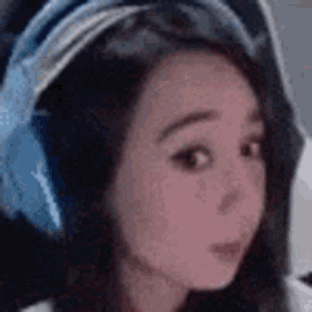 a close up of a girl wearing headphones .