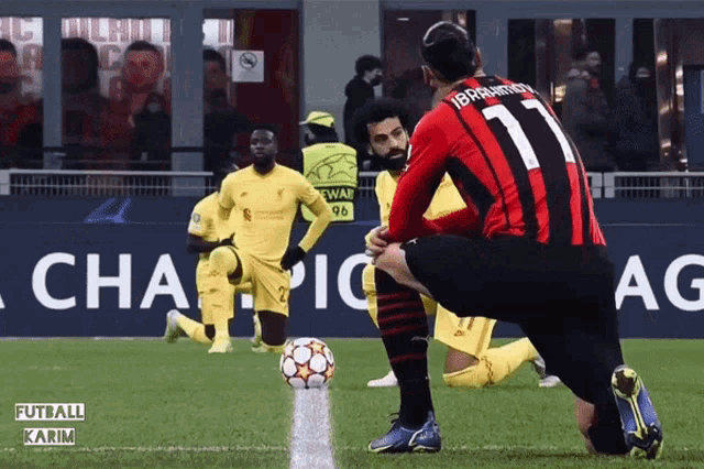 a soccer player with the number 11 on his jersey is kneeling down
