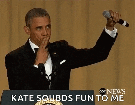 a man in a tuxedo is standing at a podium giving a speech and waving .