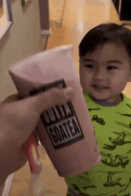 a person is holding a cup that says gotta goatea on it