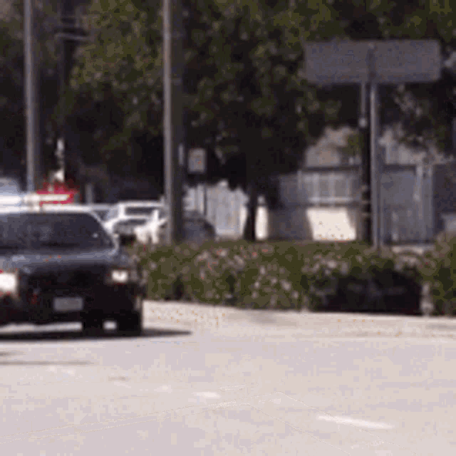 a police car is driving down a street with a blurred background