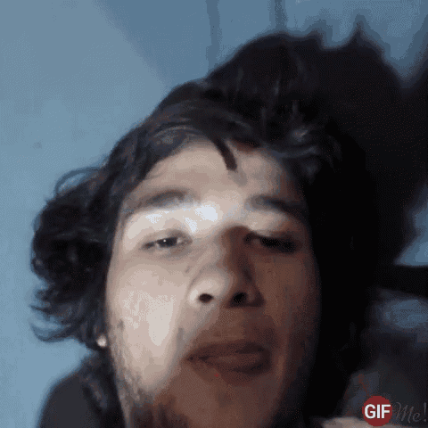 a close up of a man 's face with a gif me watermark