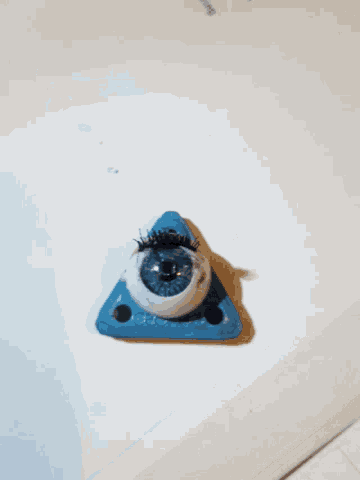 a blue triangle with a fake eye in it