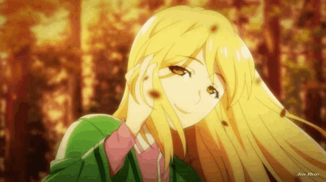 a girl with long blonde hair is smiling with her hand on her forehead