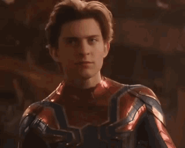 a close up of a man in a spiderman suit