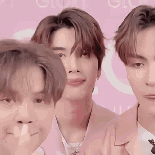 three young men are posing for a picture in front of a pink background that says gloomy