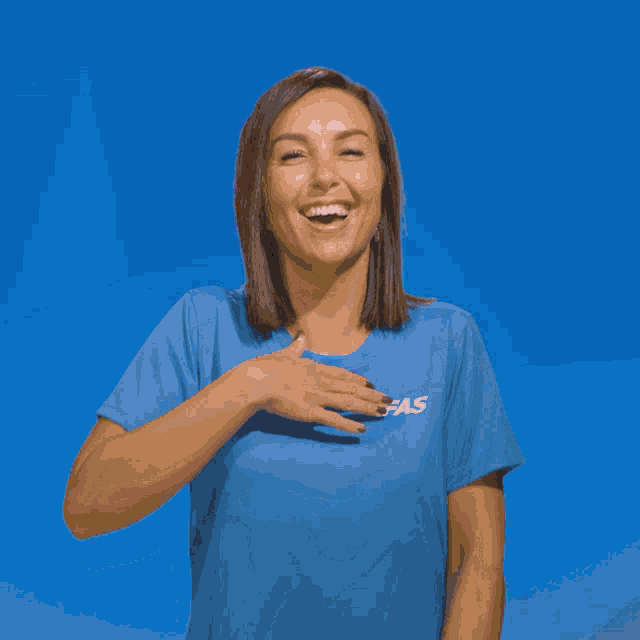 a woman wearing a blue shirt with fas on it