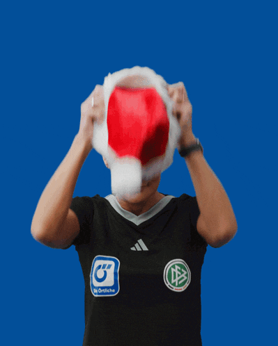 a woman wearing a santa hat and a black shirt with the letter g on the front