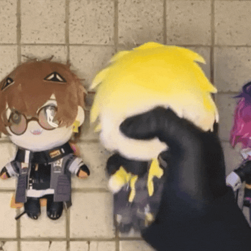 a person is holding a stuffed animal with a yellow hair and glasses