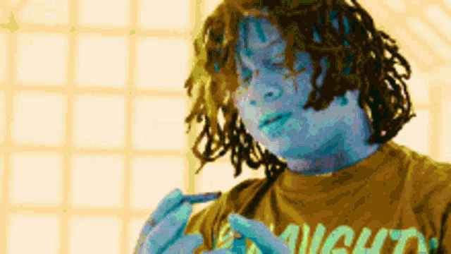 a man with dreadlocks wearing a shirt that says might