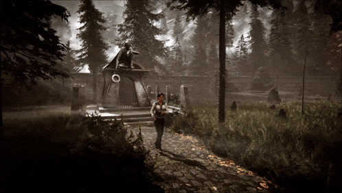 a woman walking down a path in the woods near a building