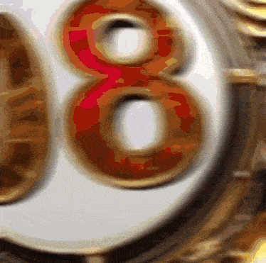 a close up of the number 8 on a white and gold background