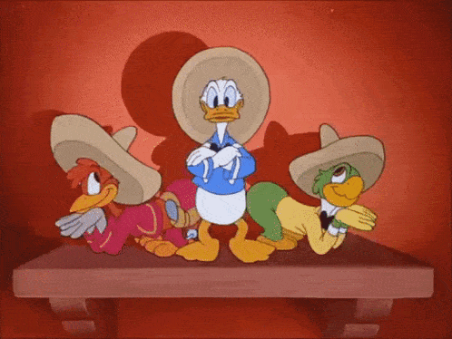 three cartoon characters wearing sombrero 's are standing on a wooden table .