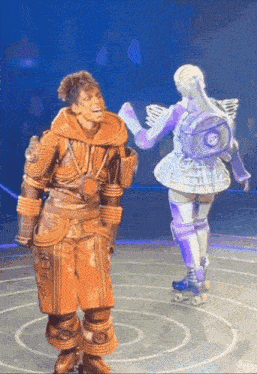 a man and a woman are dancing on a stage