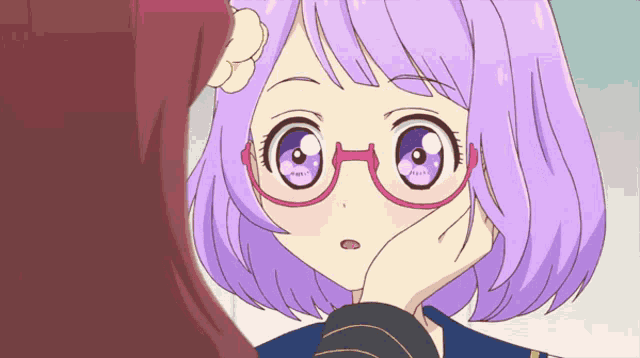 a girl with purple hair and glasses looks at another girl