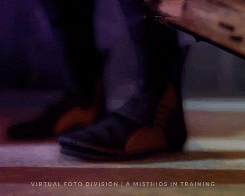 a book is laying on the floor with the words virtual foto division a misthios in training