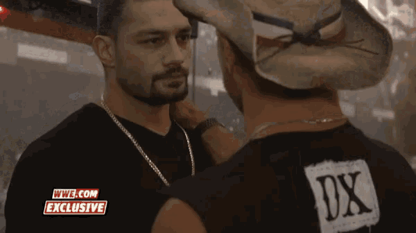 two men are standing next to each other and one has a shirt that says dx on it
