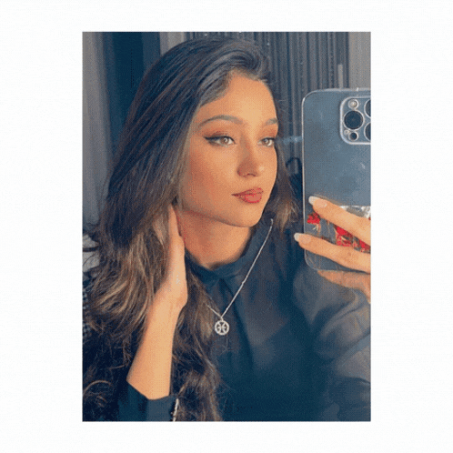 a woman is taking a selfie with her phone