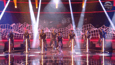 a group of people are riding exercise bikes on a stage sponsored by adivina que hago