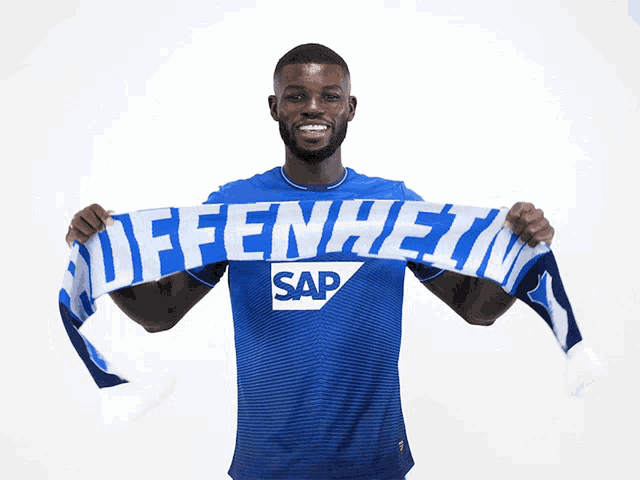 a man holding a scarf that says offenheim sap on it