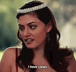 a woman with a tiara on her head says i have claws
