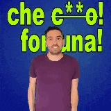 a man in a purple shirt is making a funny face while standing in front of a blue background .