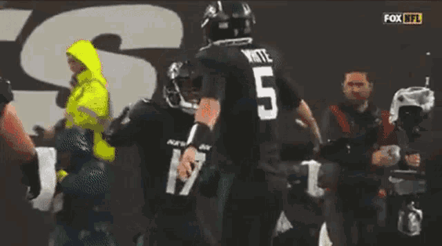 a football player with the number 5 on the back of his shirt