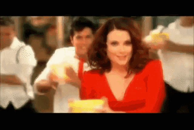 a woman in a red dress is holding a glass of lemonade