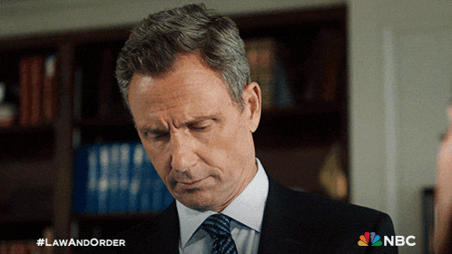 a man in a suit and tie with the hashtag lawandorder on the bottom right