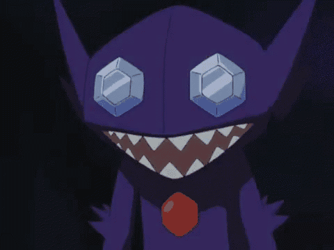 a close up of a purple monster with big teeth and a red necklace .