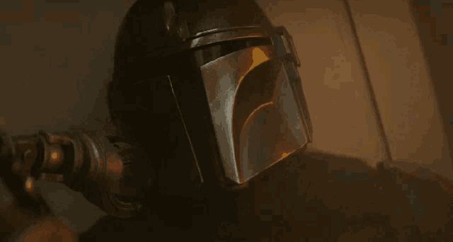 a man with blood on his face is wearing a helmet .