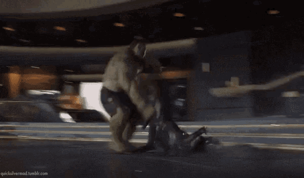a hulk is fighting a black widow in a room .