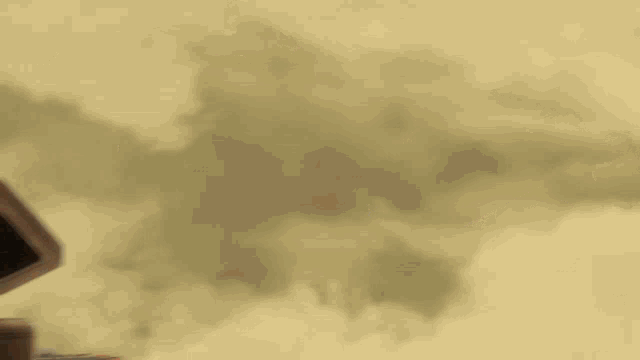 a blurred image of a building with smoke coming out of the windows