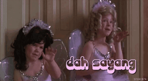 two little girls in fairy costumes are sitting next to each other with the words dah sayang written on the bottom