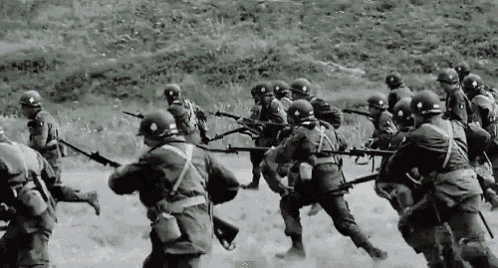 a black and white photo of soldiers holding guns