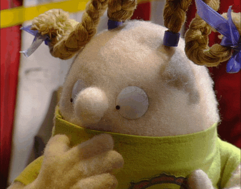 a stuffed animal wearing a green shirt with a rainbow on it