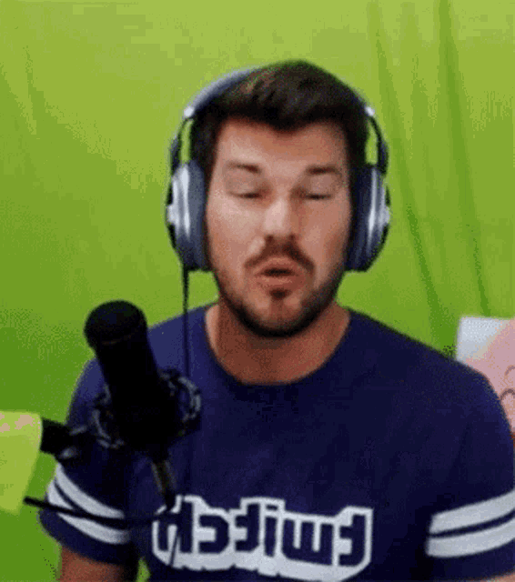 a man wearing headphones and a shirt that says twitch