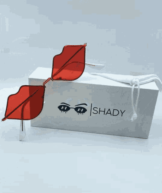 a pair of shady sunglasses sitting on top of a box