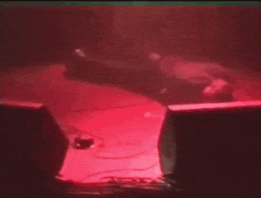 a red light is shining on a table in a dark room .