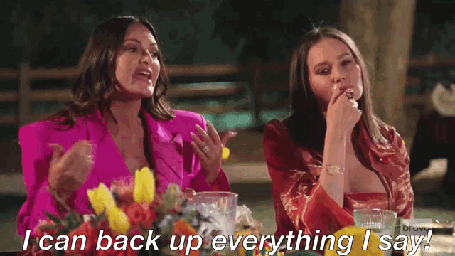 two women are sitting at a table and one of them is saying i can back up everything i say