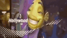 a cartoon character from shrek is smiling in front of a hollywood sign .