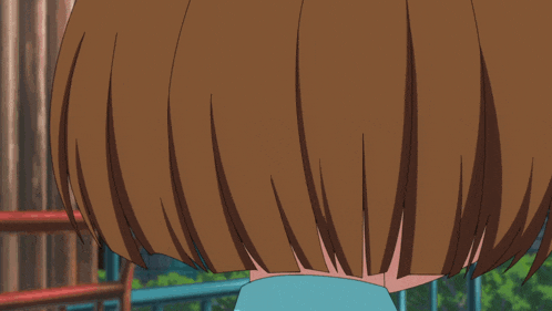a close up of a girl 's face with brown hair and orange eyes