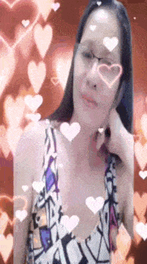 a woman wearing glasses and a dress with hearts around her face .